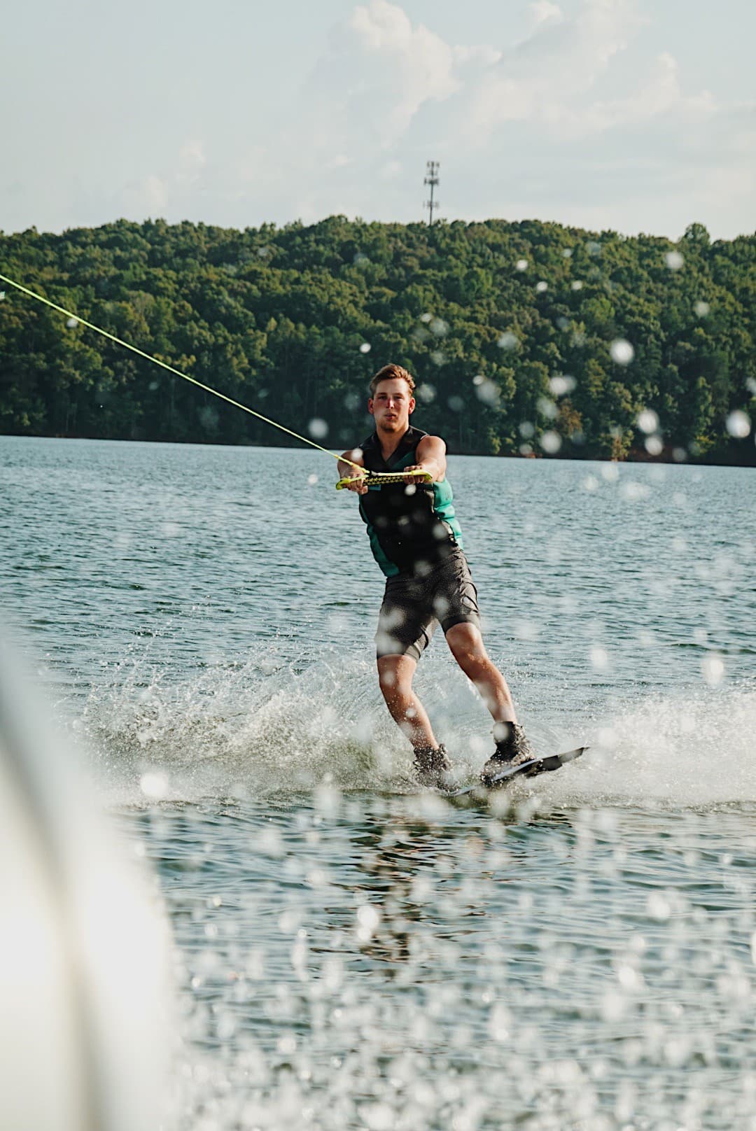 A rider carving across Lake Chickamauga behind the wake boat